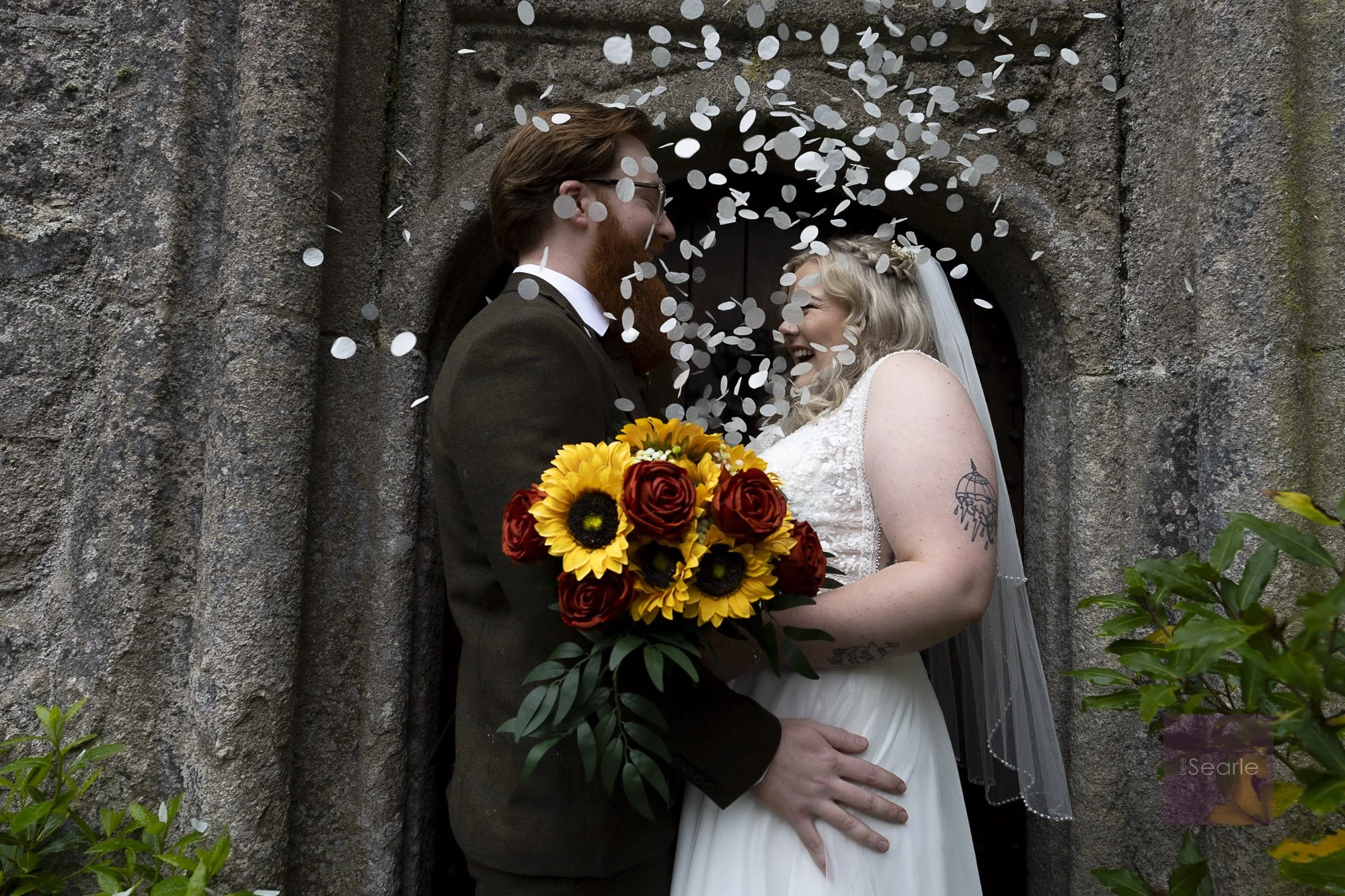 Confetti in the granite doorway after the ceremony at Pengersick Castle