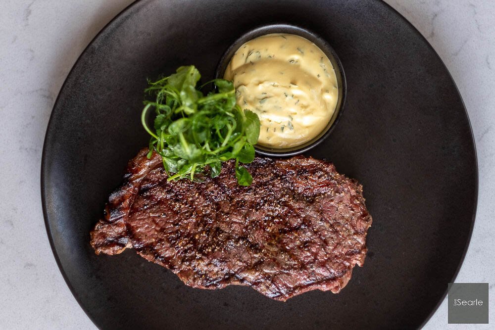 Steak with béarnaise and herbs on a dark plate, restaurant food photography in Cornwall