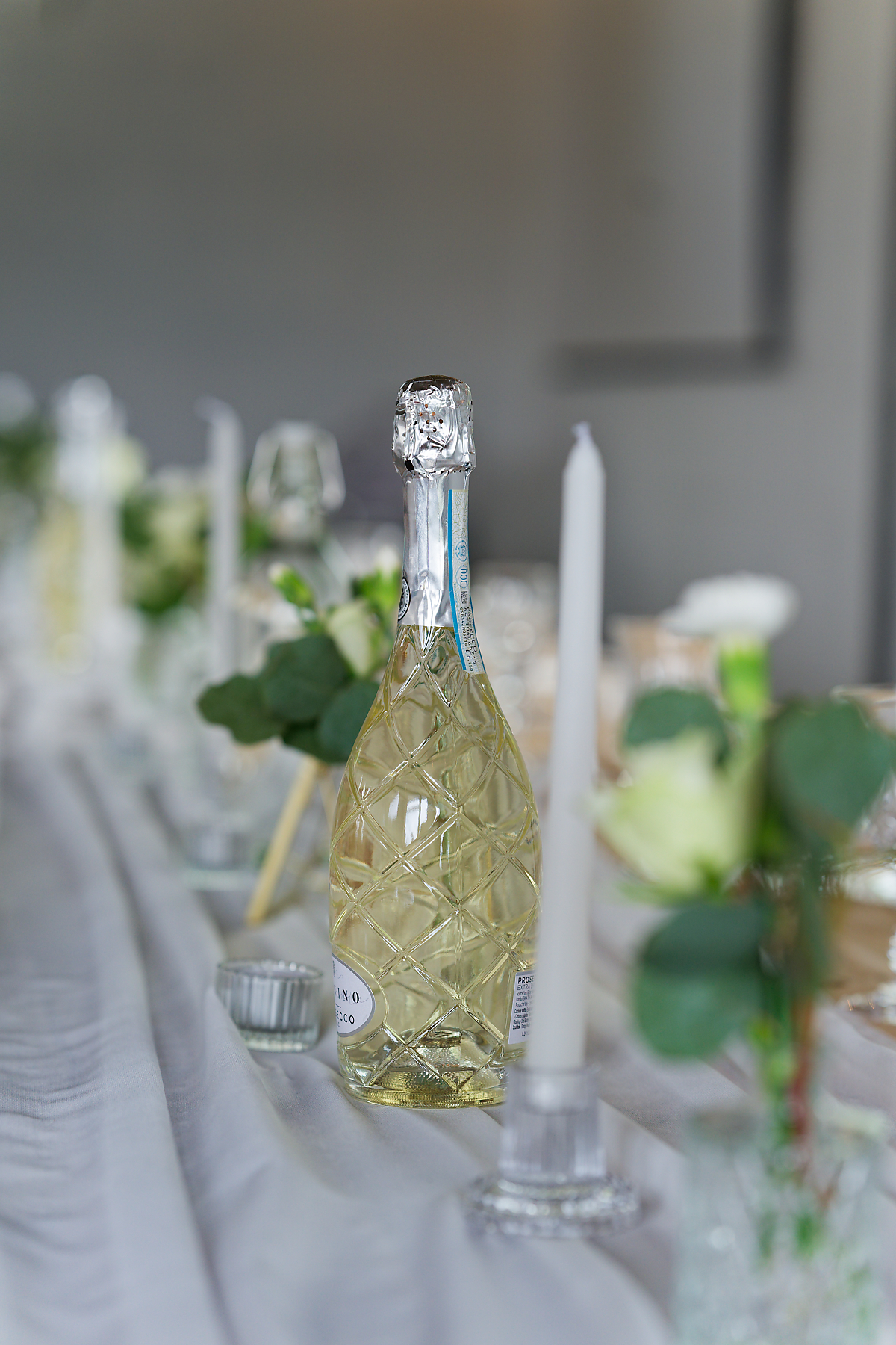 Chilled bottle of prosecco on the wedding breakfast table