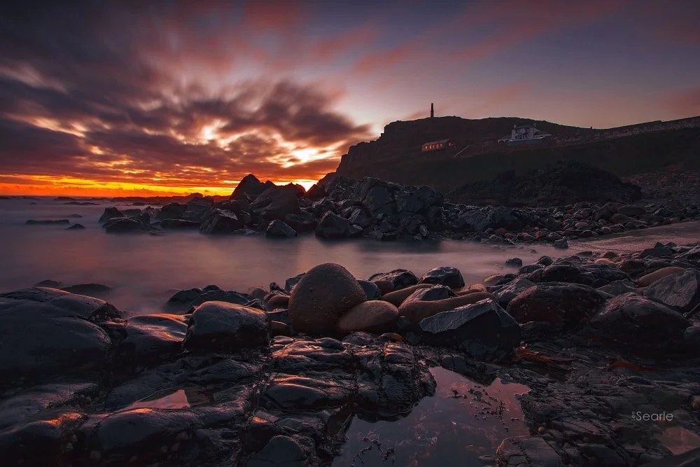 Fiery sunset over the rocky shoreline at Cape Cornwall near Penzance