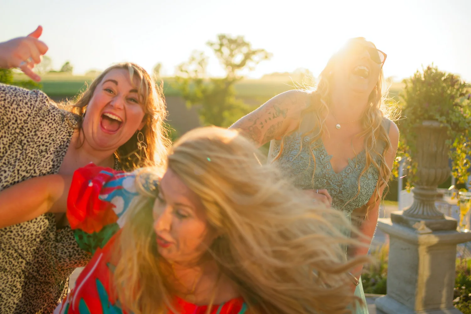 Wedding guests dancing in the evening sun