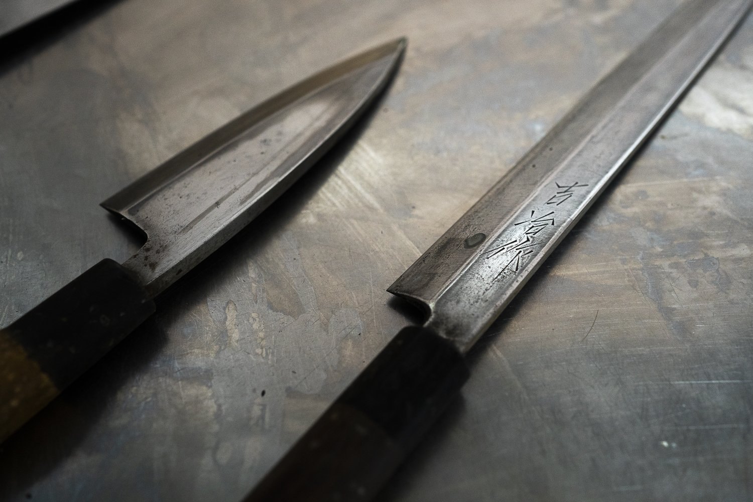 Chef's knives on a steel pass in a Cornish restaurant kitchen, food photography by Lee Searle